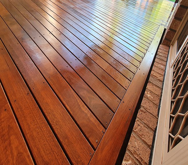 Freshly oiled Australian spotted Gum timber outdoor covered deck with Merbau stain at Residential Home, still wet and yet to dry