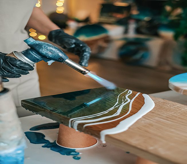 gas burner burns a board with epoxy resin with fire